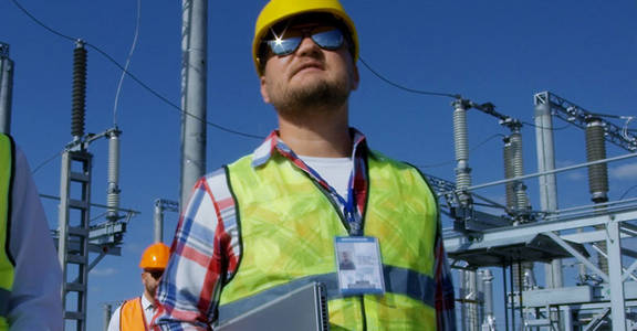 Some workers inspecting a test station
