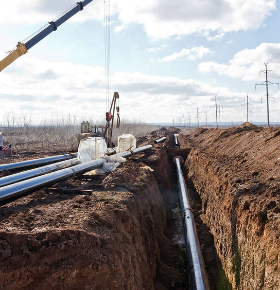 High voltage metal rods being connected in pit, parallel to the power lines to the right